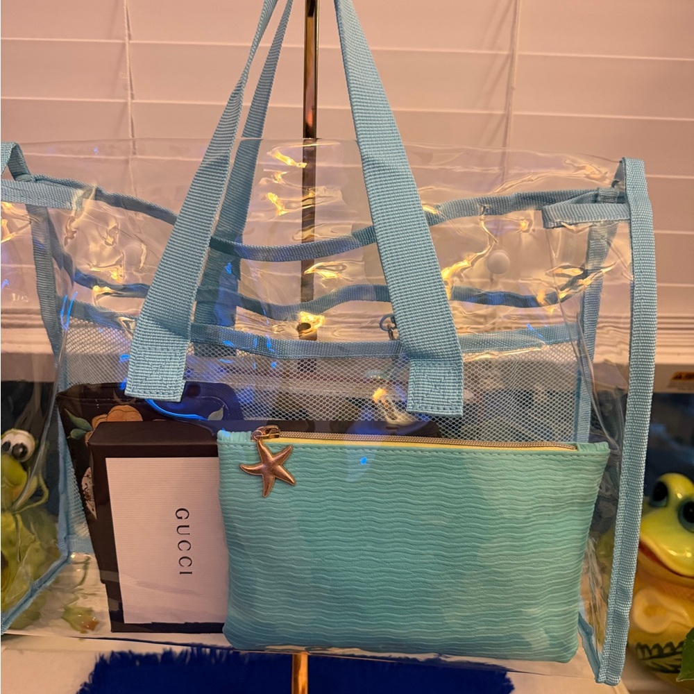 Brand new. Transparent, very thick and durable Tote with Blue Trim
